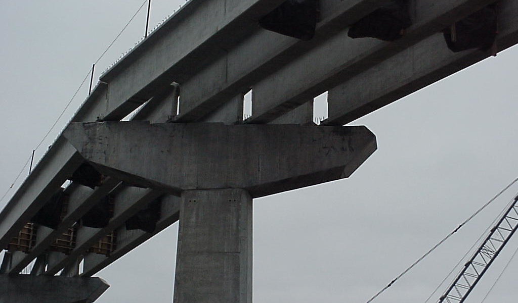 overpass under construction with light through the beams