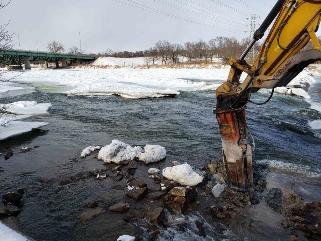 Dam demolition occuring in ice covered Des Moines river