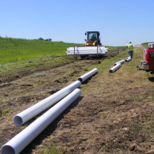 pipe lining laying on grass waiting to be installed