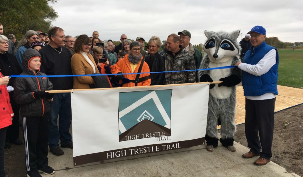 People gathered to celebrate the completion of the first segment of a 9-mile High Trestle Trail extension.