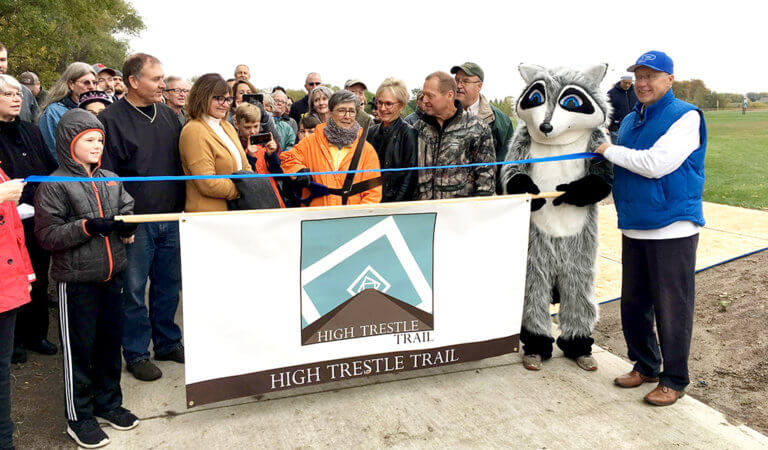 People gathered to celebrate the completion of the first segment of a 9-mile High Trestle Trail extension.