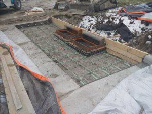 two metal stormwater inlets before concrete is added around them