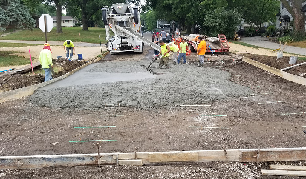 construction workers laying wet concrete