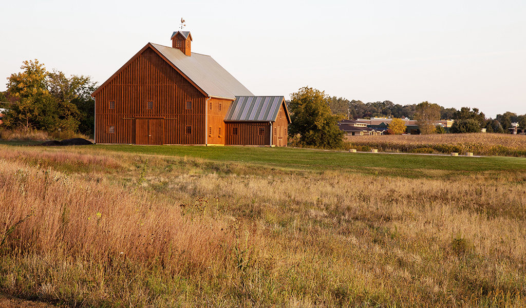 Large wood barn in grassy area