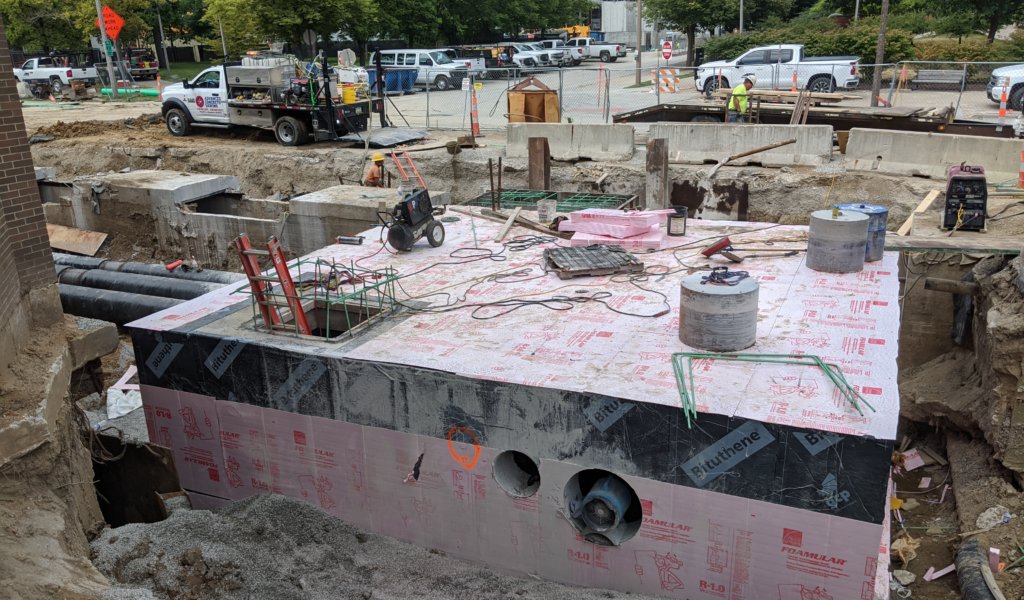 concrete vault in hole next to street