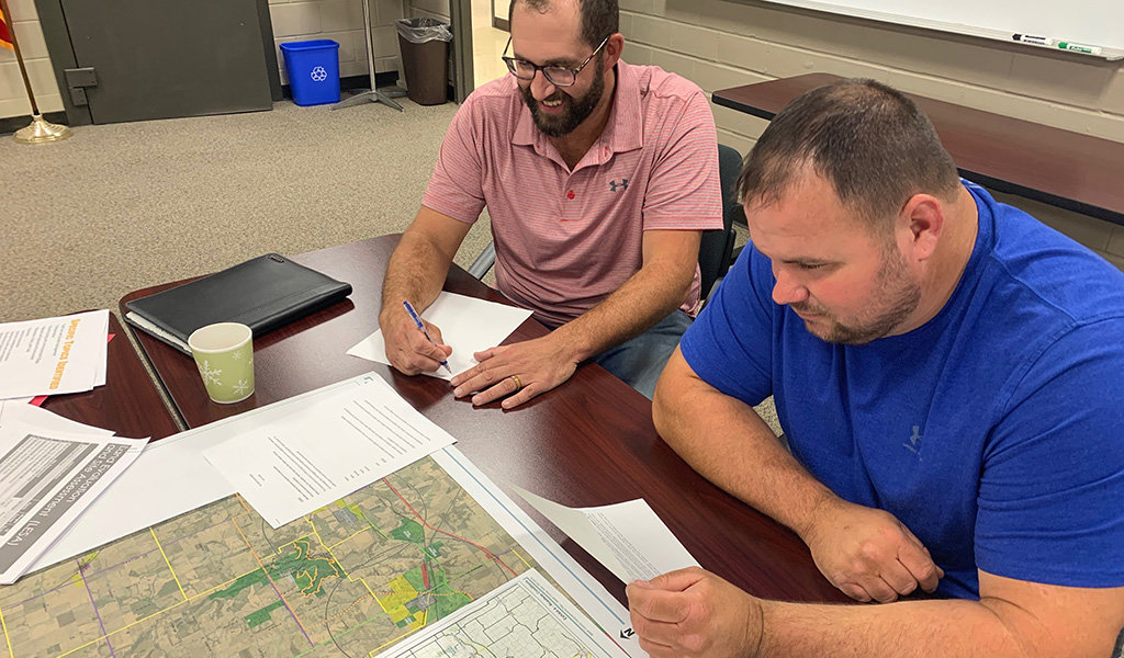 two men looking at a planning map