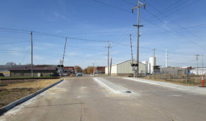 new concrete median leading up to railroad crossing
