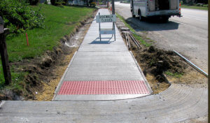 new ADA compliant sidewalk with red domes by street