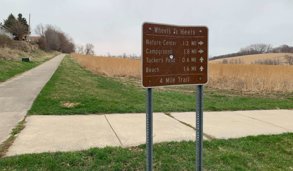 large brown sign giving distance directions