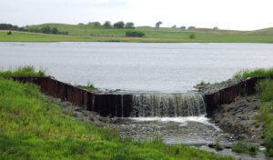 Pond with low-head weir overflowing