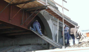 Construction workers under bridge