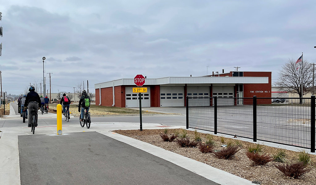 Bicyclist ride past the Council Bluffs fire station