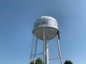 White Bedford water tower on a clear day