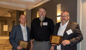 Rich Voekler, Andy Meesman and Jim stand with ACEC awards