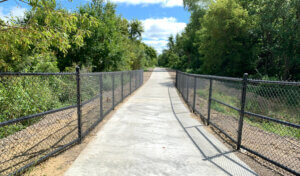 Trail with black fencing one either side