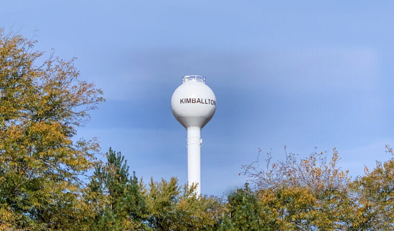kimballton water tower above trees in blue sky