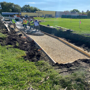 construction workers pouring concrete for stormwater drainage