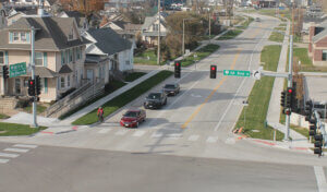 Overlaid pavement on 1st Ave with railroad crossing in the background