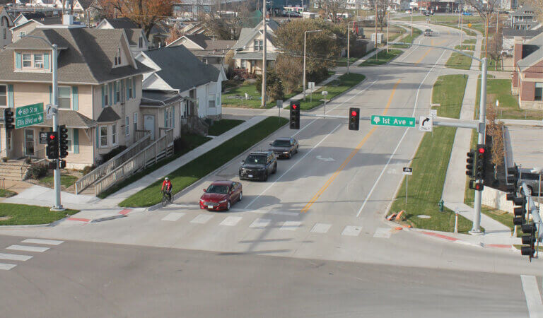 Overlaid pavement on 1st Ave with railroad crossing in the background