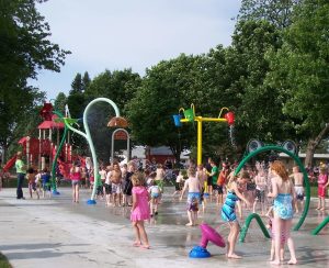 dozens of children playing in splash pad
