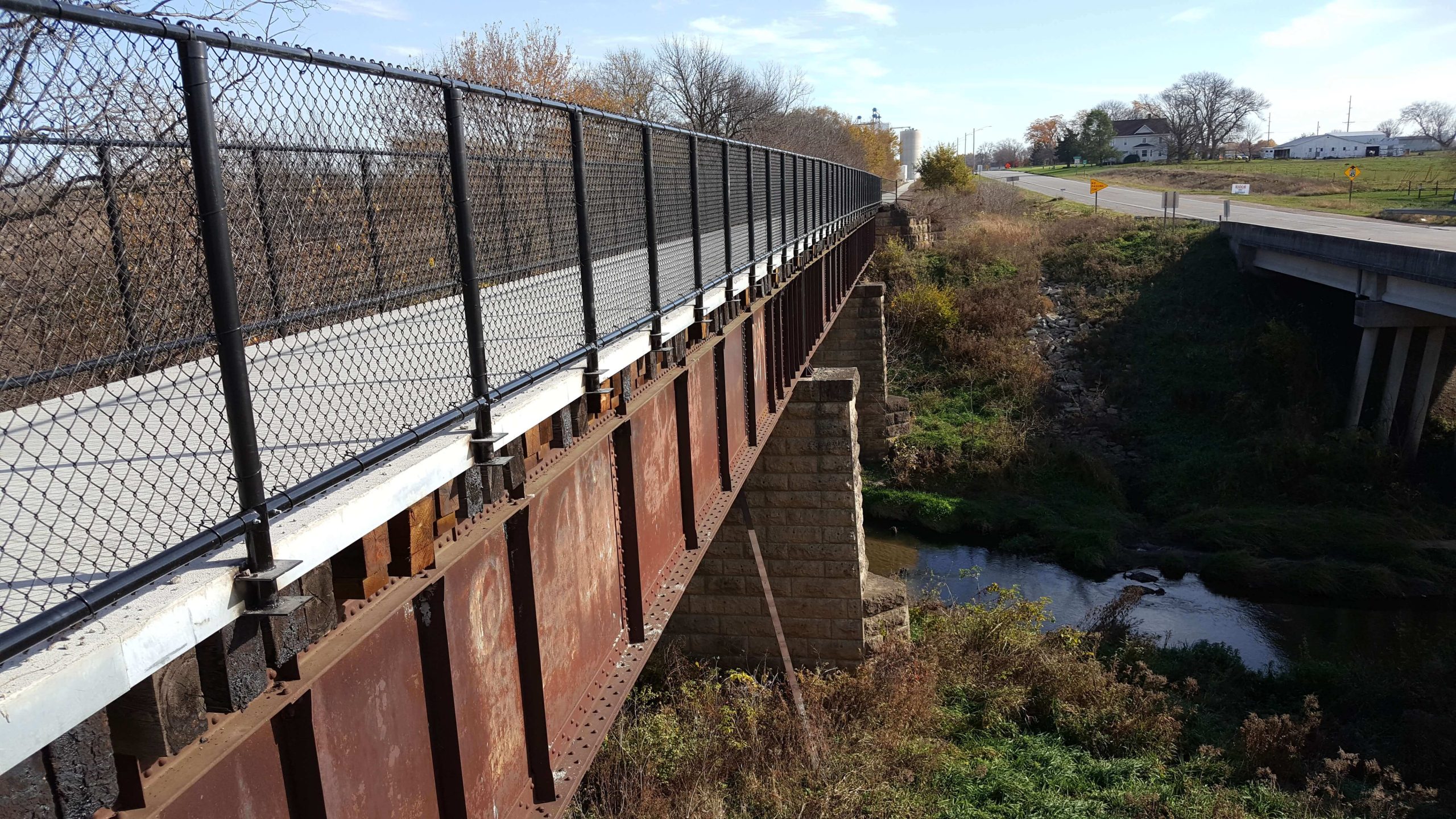Steel trail bridge over a stream of water