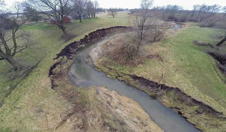 camp creek iowa|Eroded banks of Spring Creek in Iowa|Mud Camp Spring Watershed Logo|group gathering around a table at public meeting||Mud Camp Spring Creek Watershed Overall Prioritization Map|mud creek showing erosion along the banks