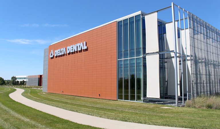 New Delta Dental Signage on newest addtion|floor to ceiling glass paneling on newest delta dental addition|perforated sunscreen block sunlight from exterior glass wall of delta dental expansion||delta dental exterior glass wall shades