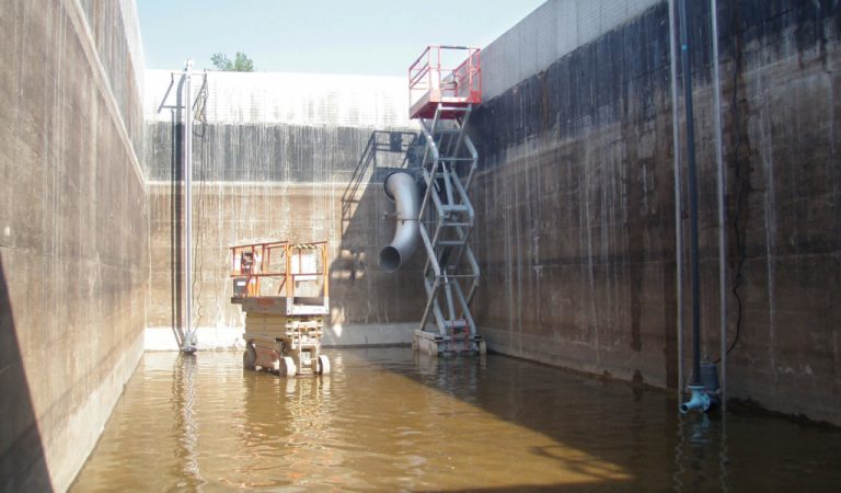 Inside of the Disinfection-Flow Equalization Tank.|Inside of the SBR tank looking at the aeration piping system.|Inside of treatment tank looking at piping