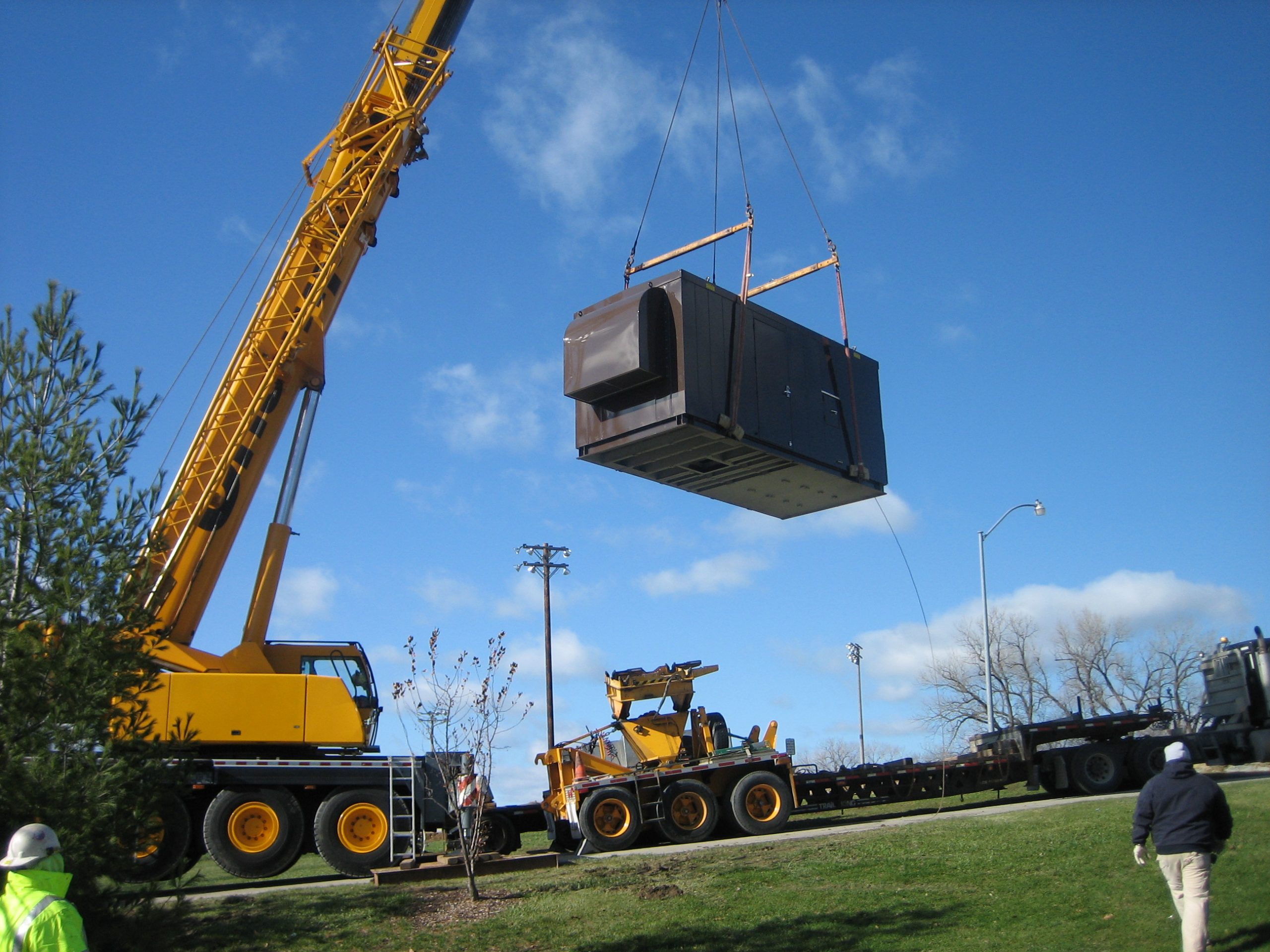 emergency generator being lowered into position by a crane at doanes park in pleasant hill iowa