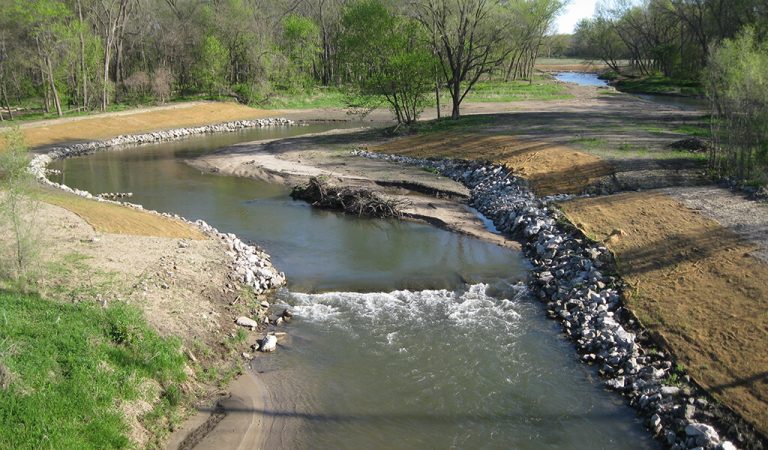 Fourmile creek rip rap middle of the stream||Environmental scientist out testing a stream|Watershed management authorities out working|Mother geese swimming a stream with their goslings
