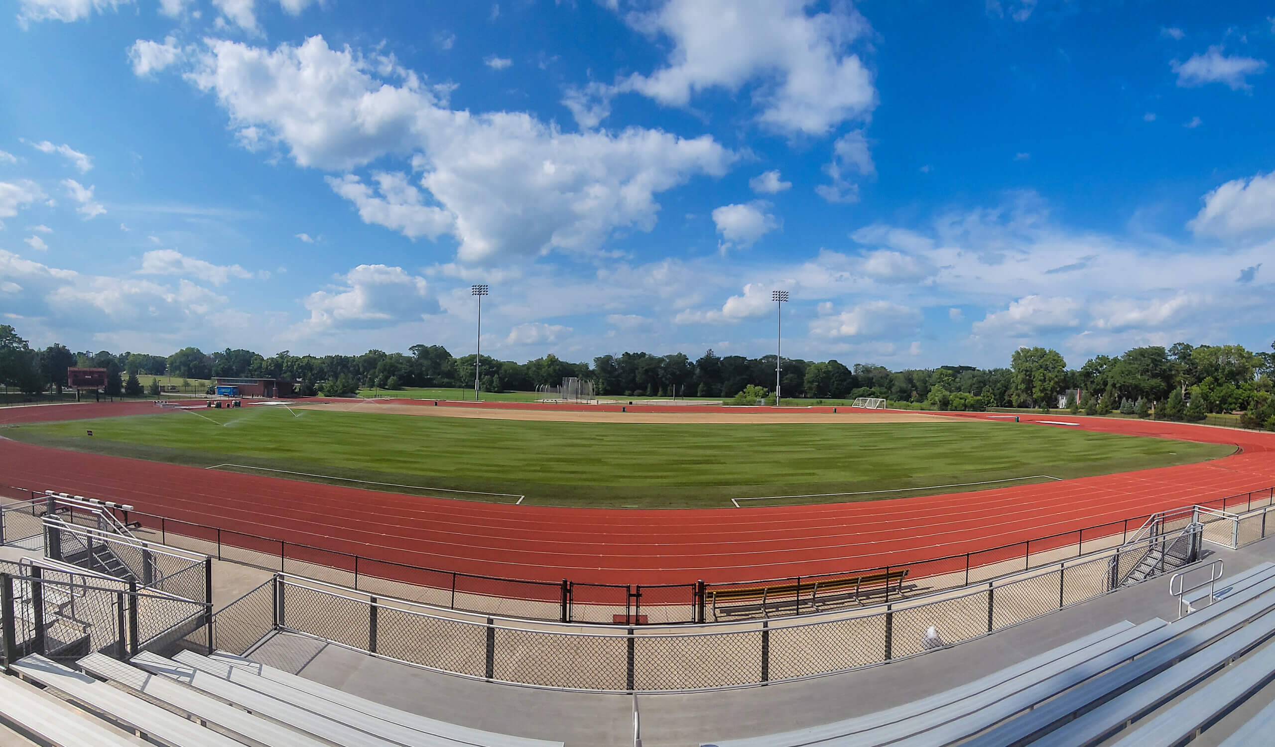 Panoramic view of a soccer field.|||Grass stitching machine on soccer field|College community members helping lay down new sod on Iowa State's soccer field.|close up look at new soccer field sod.|drainage lines on a soccer field