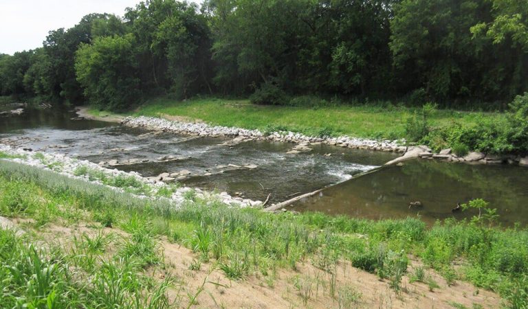 stream with rock ripple rapids|Restored streambank with rip rap rock|roller rapids at base of lowhead dam|construction equipment in river|Ioway Creek Post Mitigation