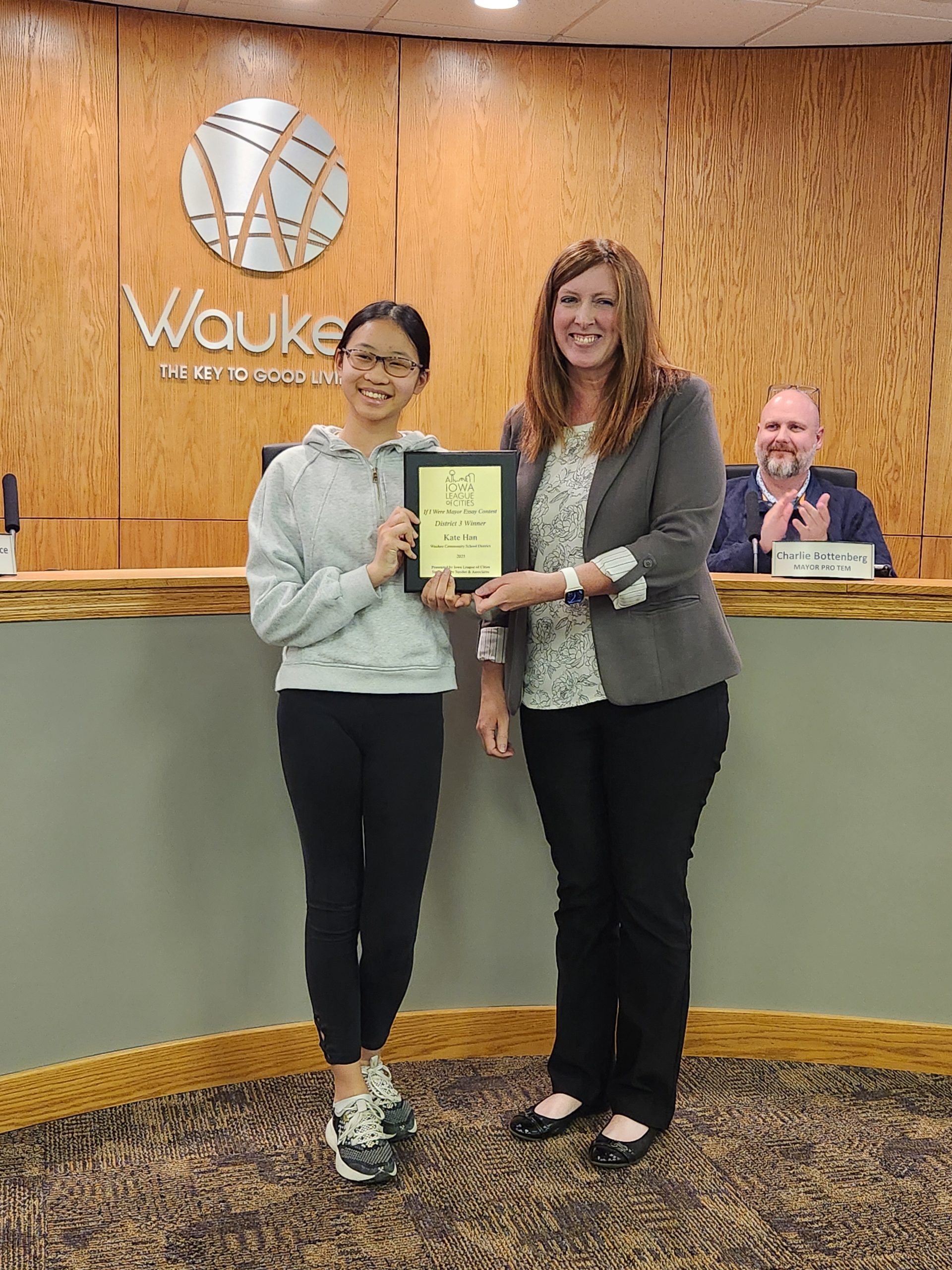 2025’s “If I Were Mayor” District 3 winner, Kate Han holding up award