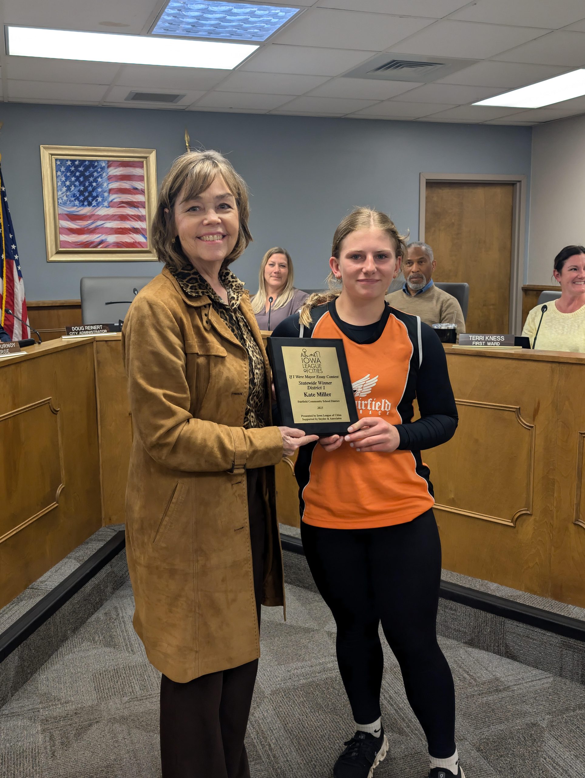 2025’s “If I Were Mayor” District 1 winner, Kate Miller holding up award