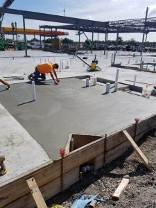 Construction workers paving the foundation for a Love's Travel stop.