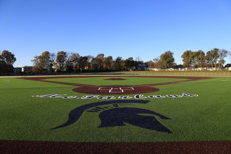 An image of the McFarland Baseball Field complete with team logos and colors.||||A rock and drain tile subbase for synthetic turf at McFarland School District's new varsity baseball field.|Rock and drain tile subbase for a synthetic turf football field at McFarland High School.|Construction of a track and field retaining wall at McFarland High School.||||||||||||A sun sets over a high school football game.||flooding on field|new dugout with benches