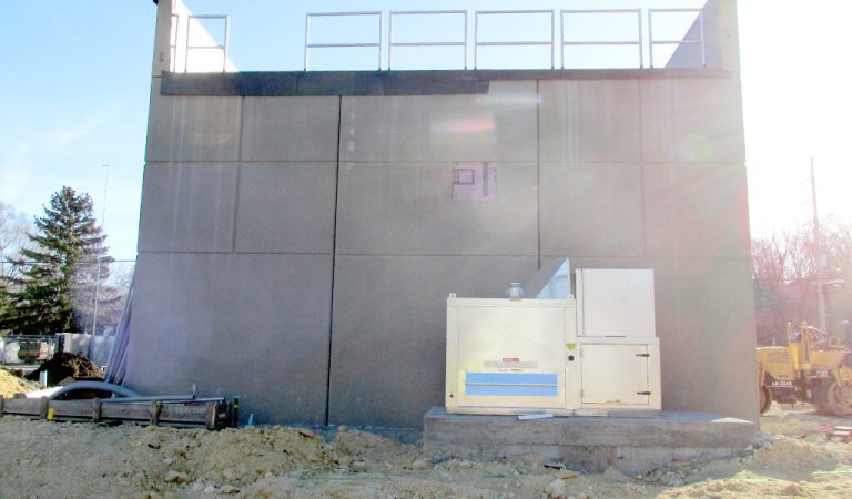 square concrete new lift station|above ground section of vertical screen|large machine used to bore holes and make way for pipe|trenchless construction|lead tubing being placed before pipe|concrete tube that will eventually house pumps|square concrete new lift station