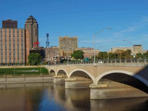 bridge with archway features over a calm river