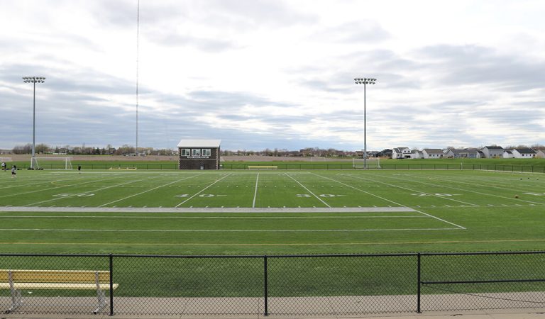 Turf football and soccer field||||Soccer players||Soccer facility with playground and public restrooms|Large parking lot outside of recreational facility
