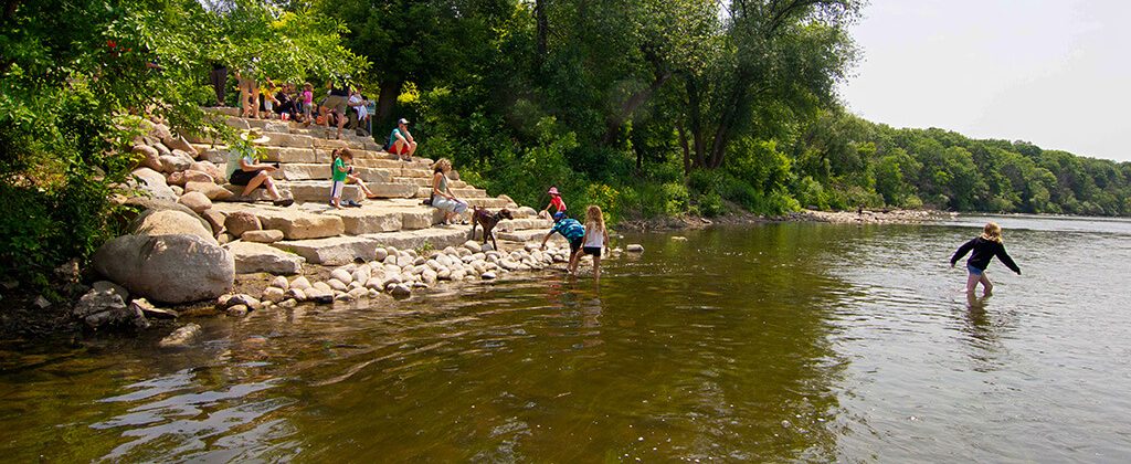 People enjoying public launch at Hubbard park|Rendering of a canoe launch in Wisconsin||||kinds in the water at Hubbard park launch|families playing in the river at Hubbard park launch