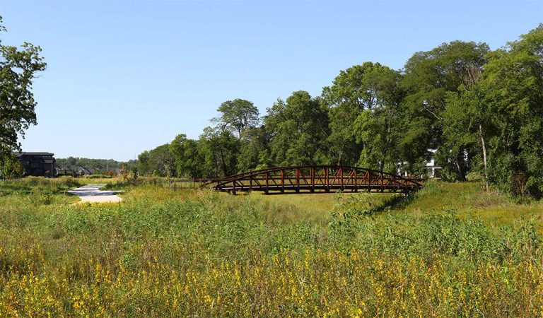 Pedestrian bridge over Sugar Creek||||creek meanders near houses||Sugar creek trail construction||||Shaded area surrounds this part of the trail|Child rides his bike over the pedestrian bridge that connects trail users to the Woodland Hills Park area|Sugar Creek Trail behind a neighborhood|Backyard view of Sugar Creek Greenway Trail
