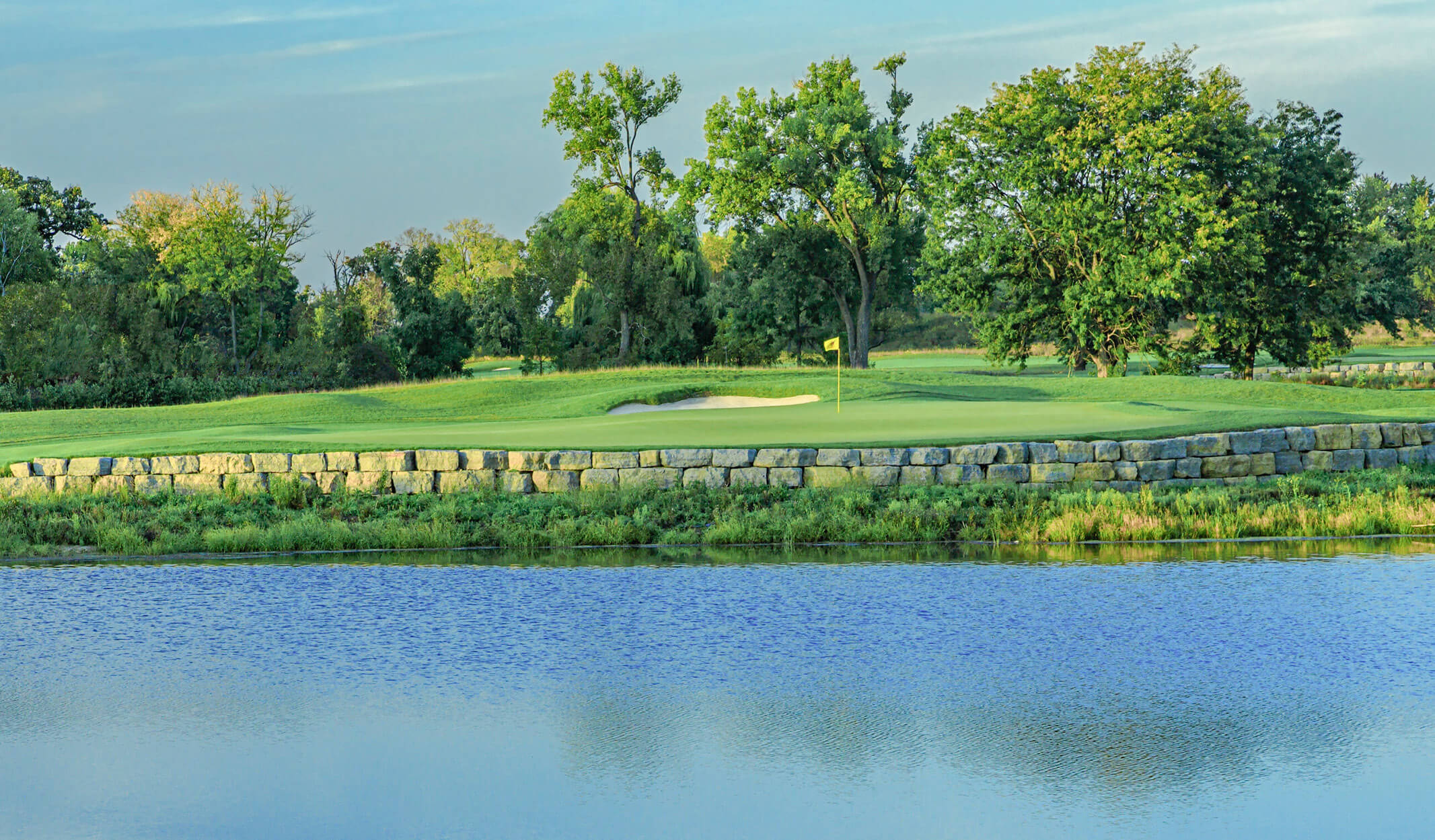 ||Restoration from Marsh to Top Tier Course with featuring bright green golf course and Trees in background|
