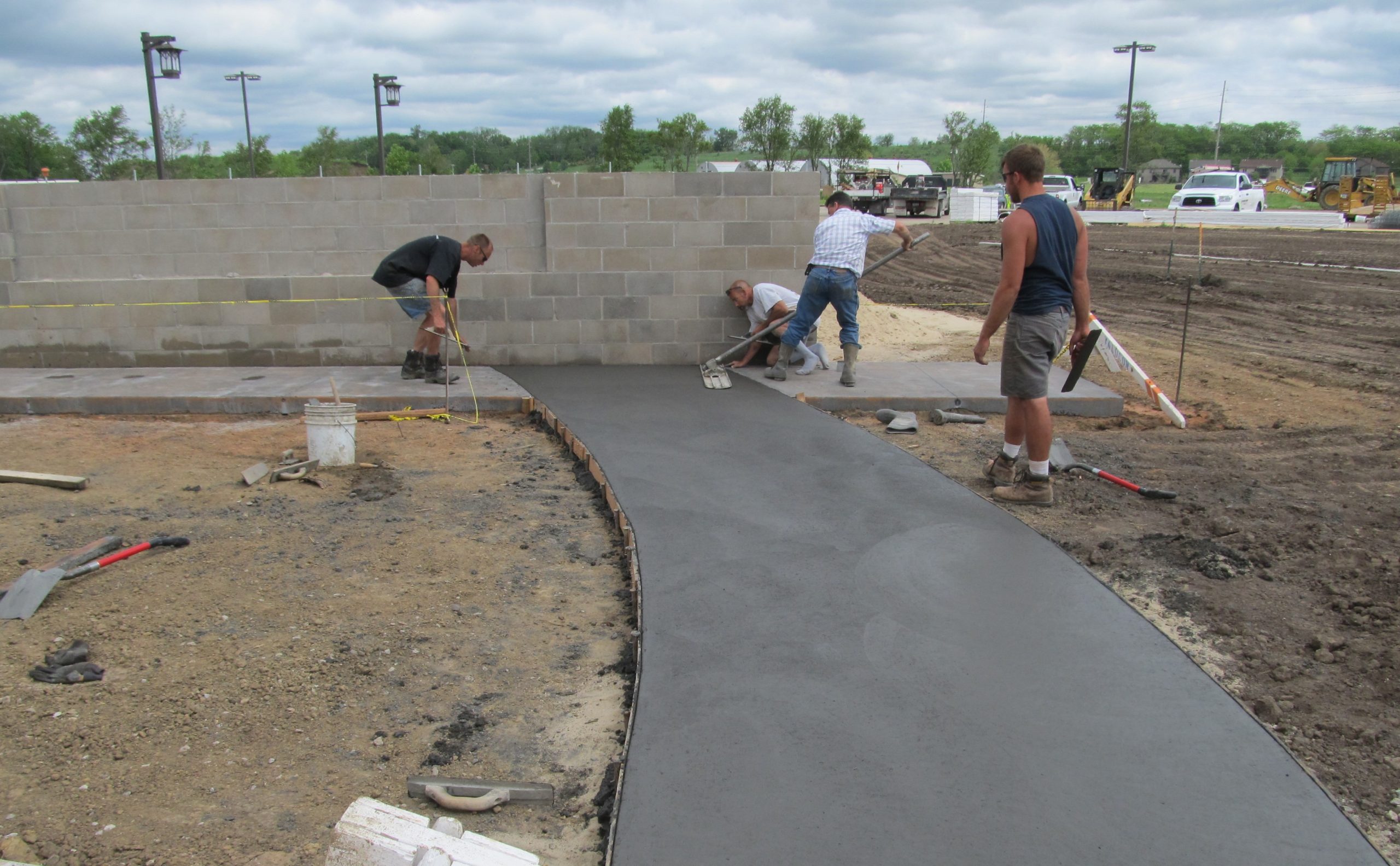 Construction crew installing pavement