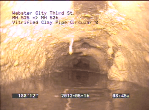 Image showing a buildup of fats, oils, and grease in a sewer system pipe.