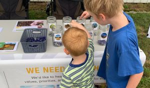 two little boys participating in mason jar activity