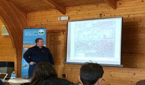 man presenting on a screen