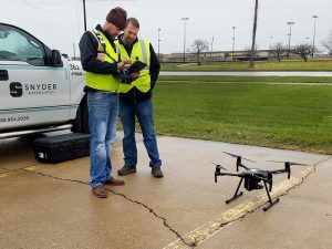 two snyder employees getting ready for drone flight