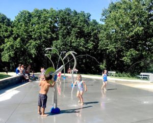kinds running in splash park waters
